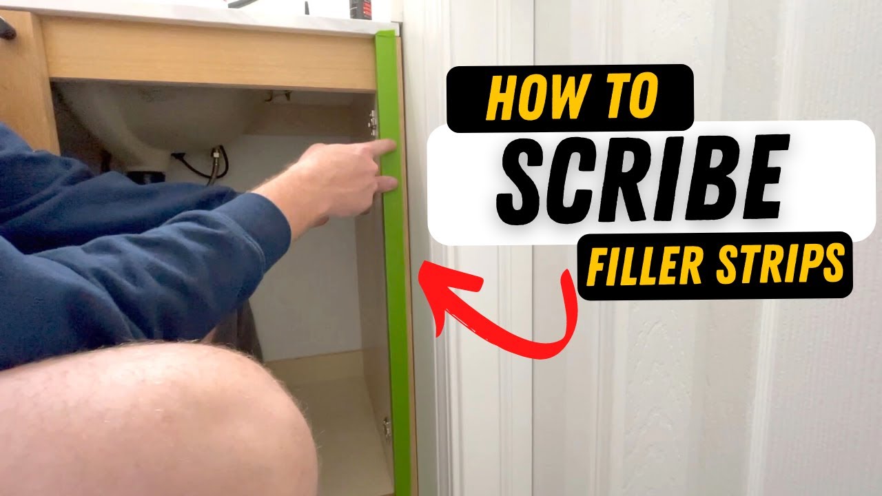 A close-up photo of a hand using a compass to trace an uneven wall line onto a vertical wooden filler strip beside a bookcase