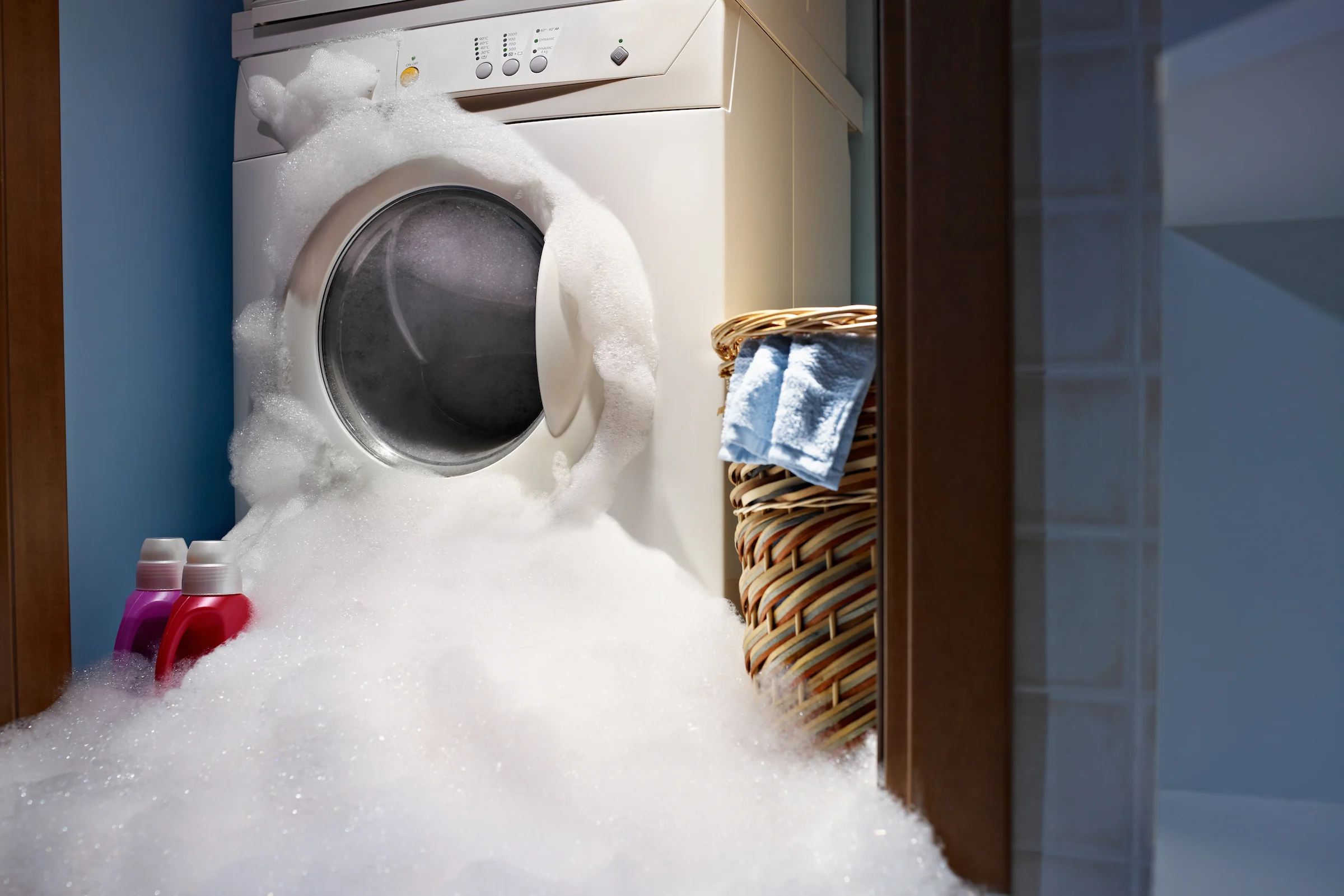 A front-loading washing machine drum filled too tightly with bulky textiles, leaving little room for movement