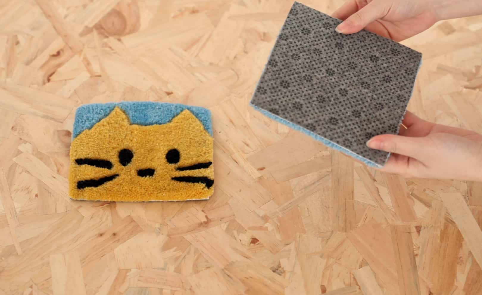 A person lifting the corner of an area rug to show the underside backing on a hardwood floor