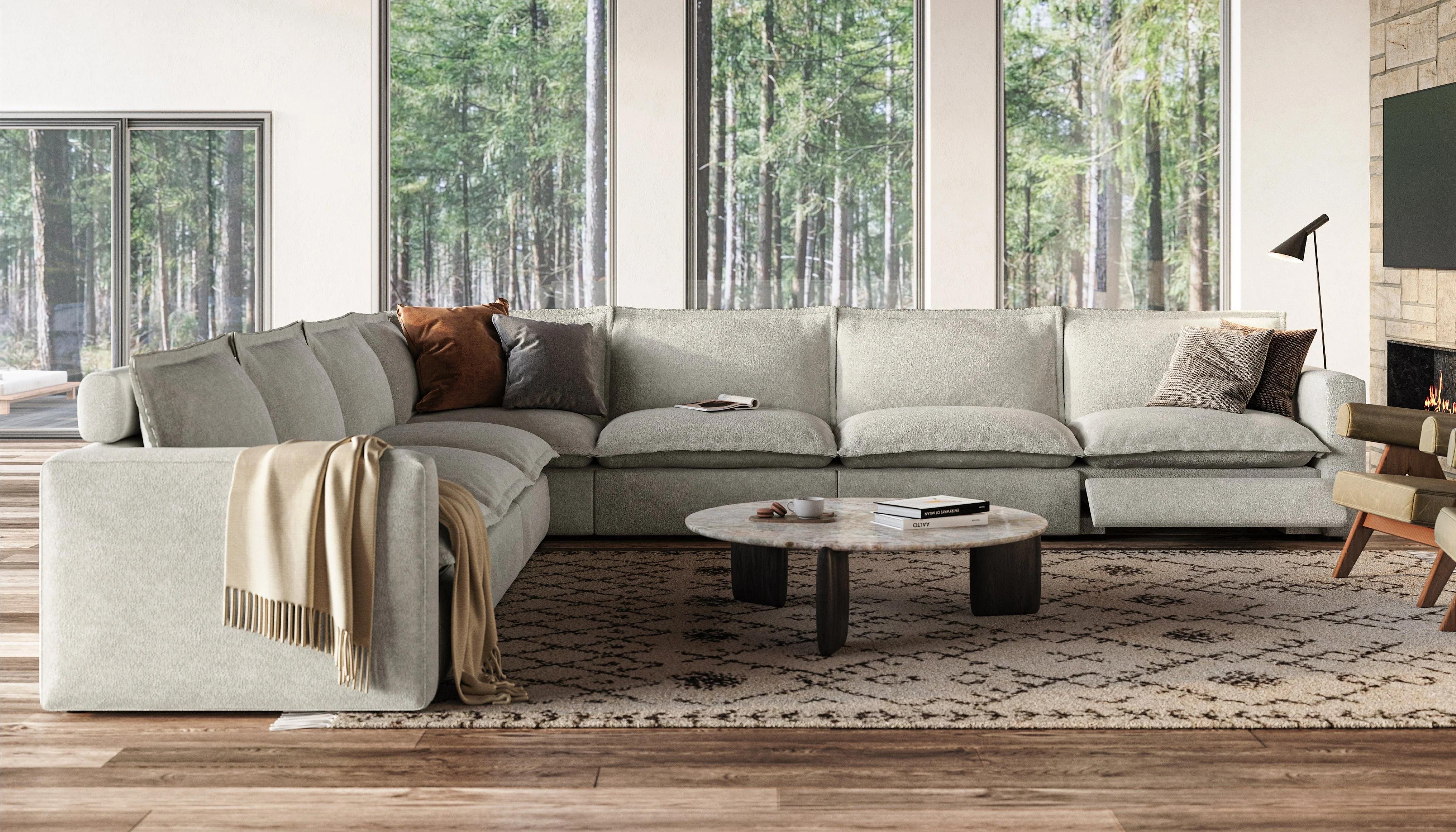 A person rearranging removable cushions on a neutral sectional sofa in a lived-in family living room, natural daylight and casual home styling