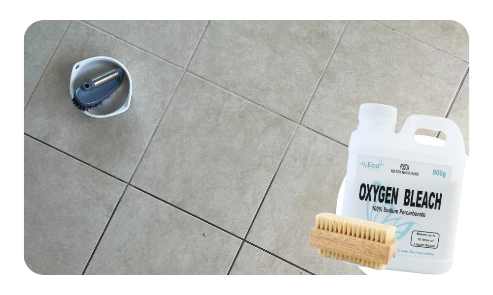 A real kitchen backsplash area with white subway tile and slightly dark grout lines, with a soft brush applying an oxygen bleach paste, warm under-cabinet lighting