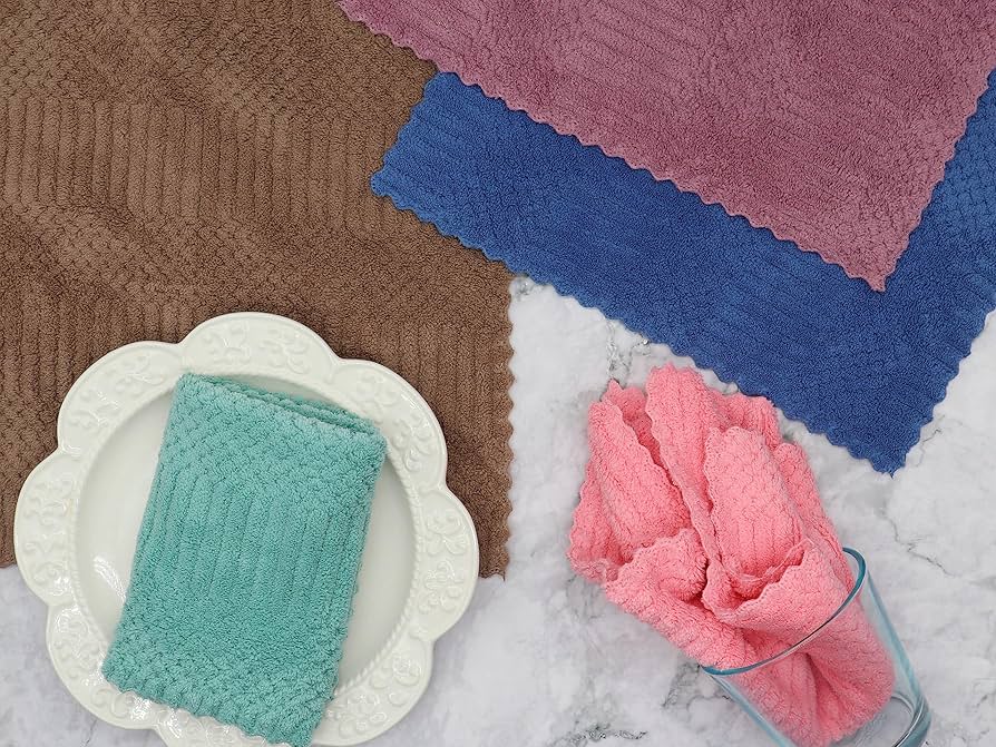 A real photo of a countertop with microfiber cloths, a small bowl of warm soapy water, a soft sponge, and a toothbrush laid out neatly for cleaning cabinets