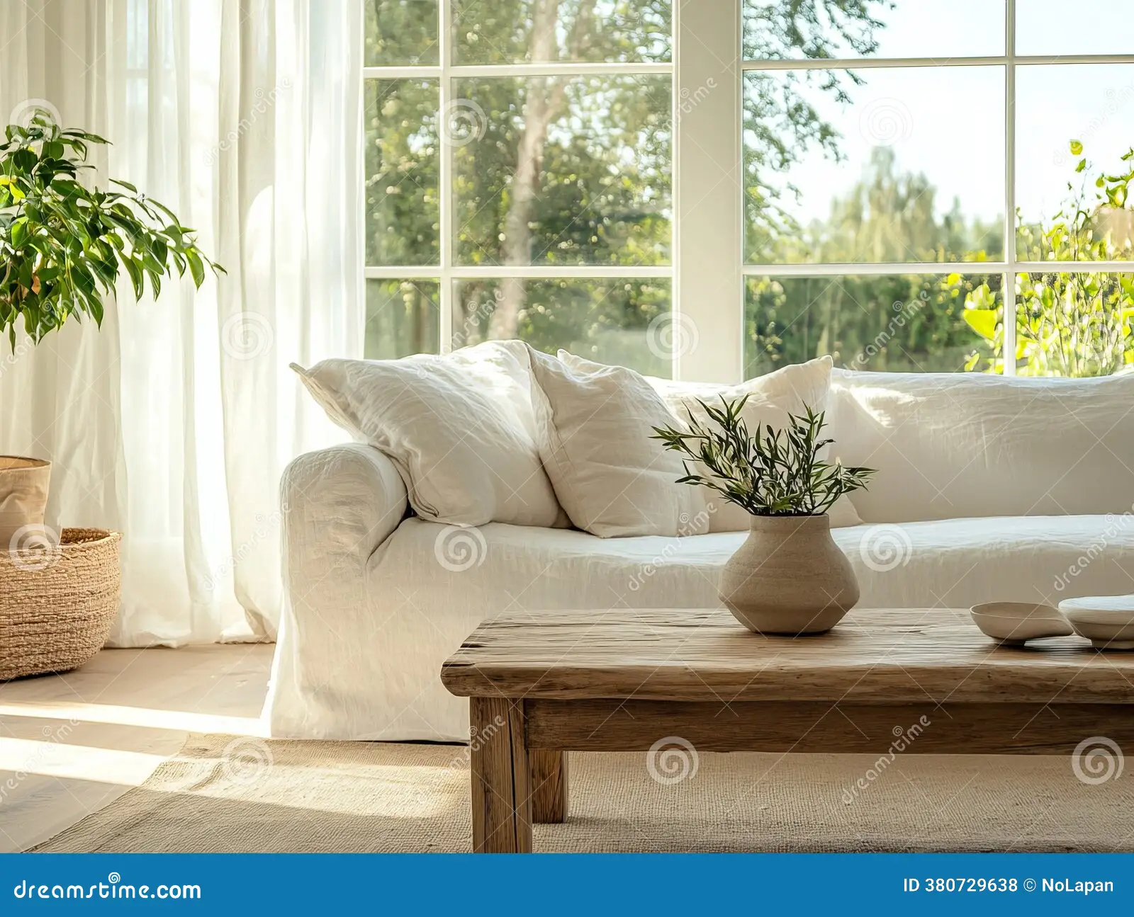 A real photograph of a cognac leather sofa in a bright living room with a natural linen throw draped over one seat