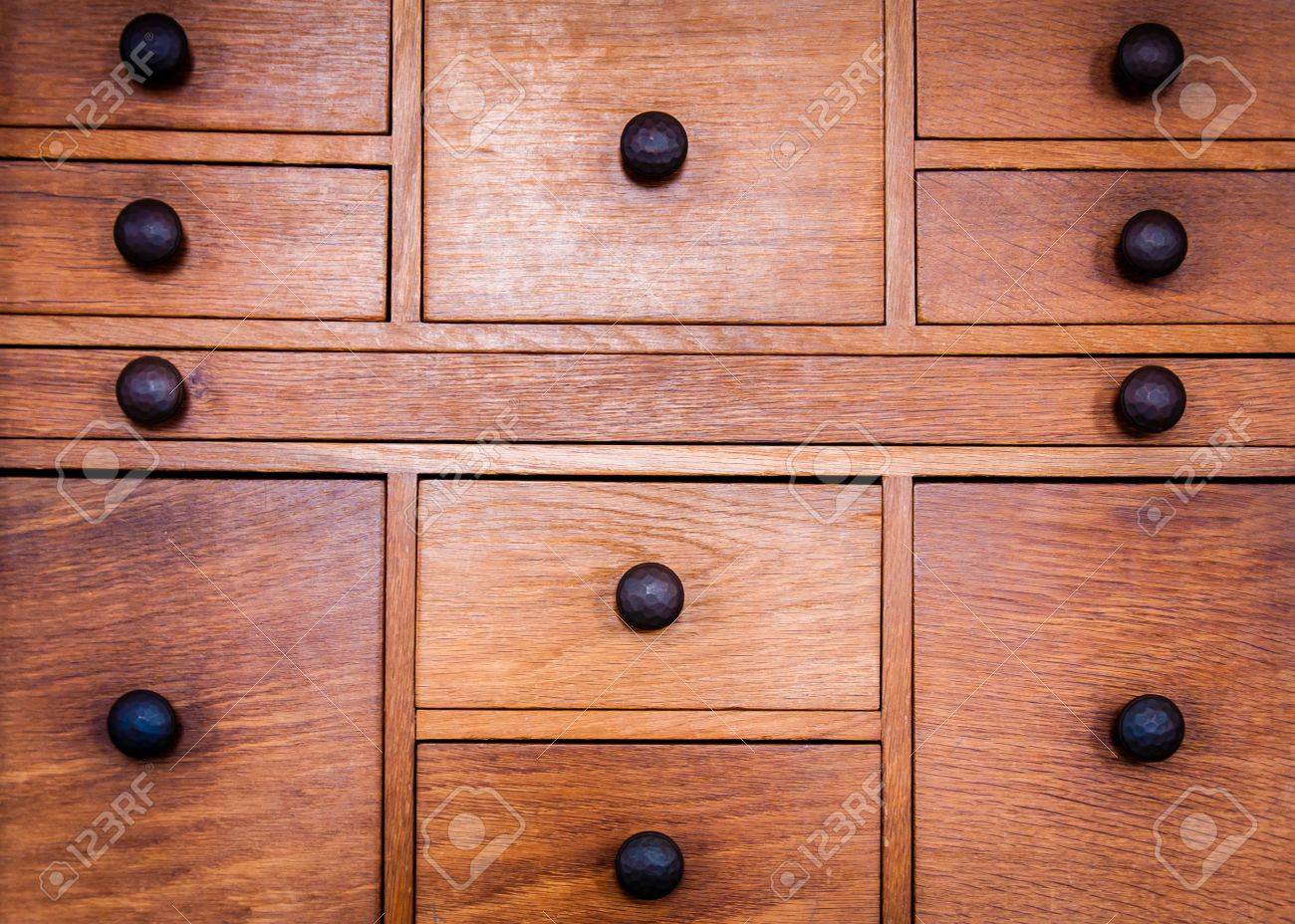 A real photograph of a vintage wooden dresser top in warm light showing subtle patina and a soft sheen on the finish