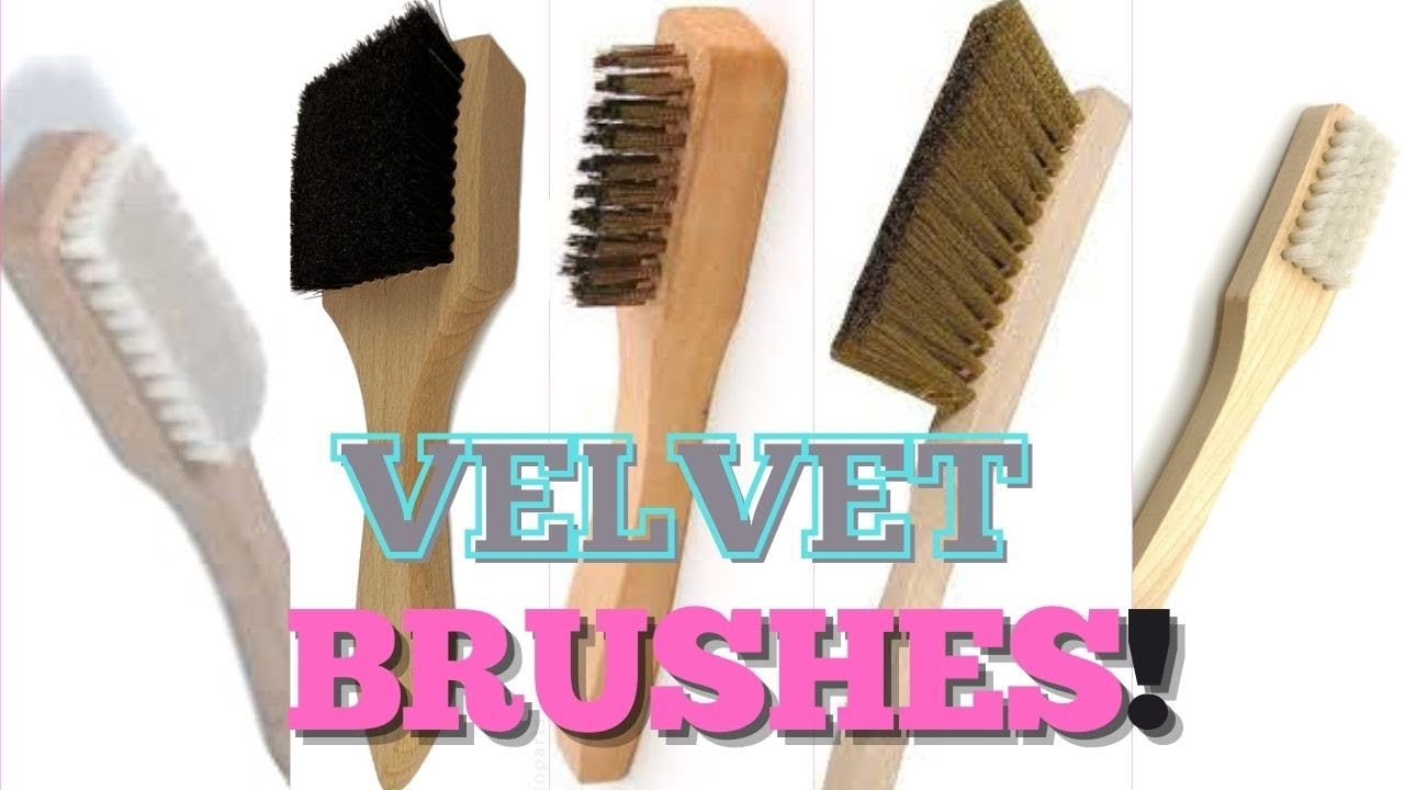 A small set of velvet cleaning supplies on a wooden coffee table, including microfiber cloths, a soft brush, and a handheld steamer