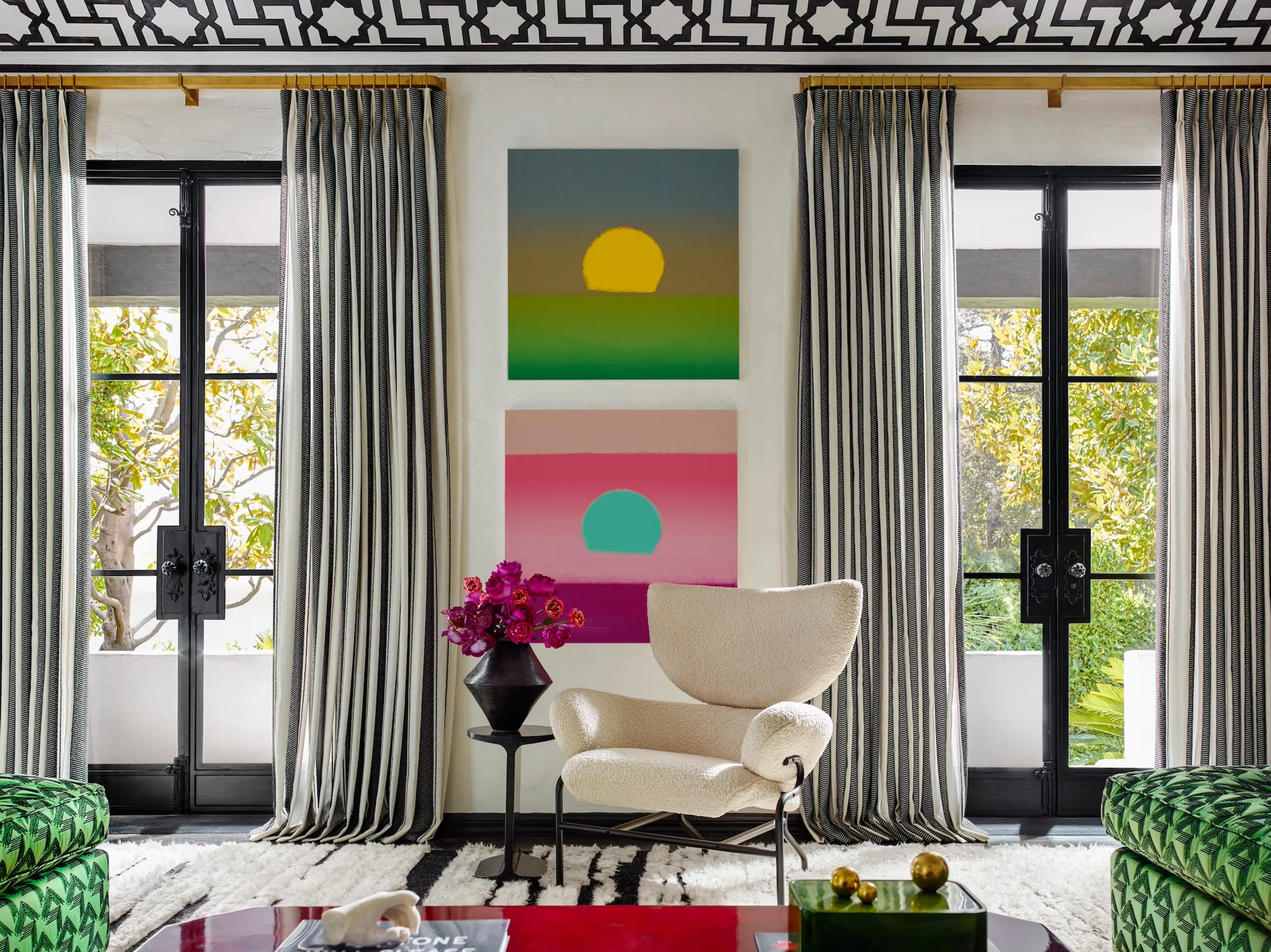 A vintage-inspired living room with heavier drapes that pool slightly on a wooden floor near a tall window, warm lamplight highlighting the fabric folds