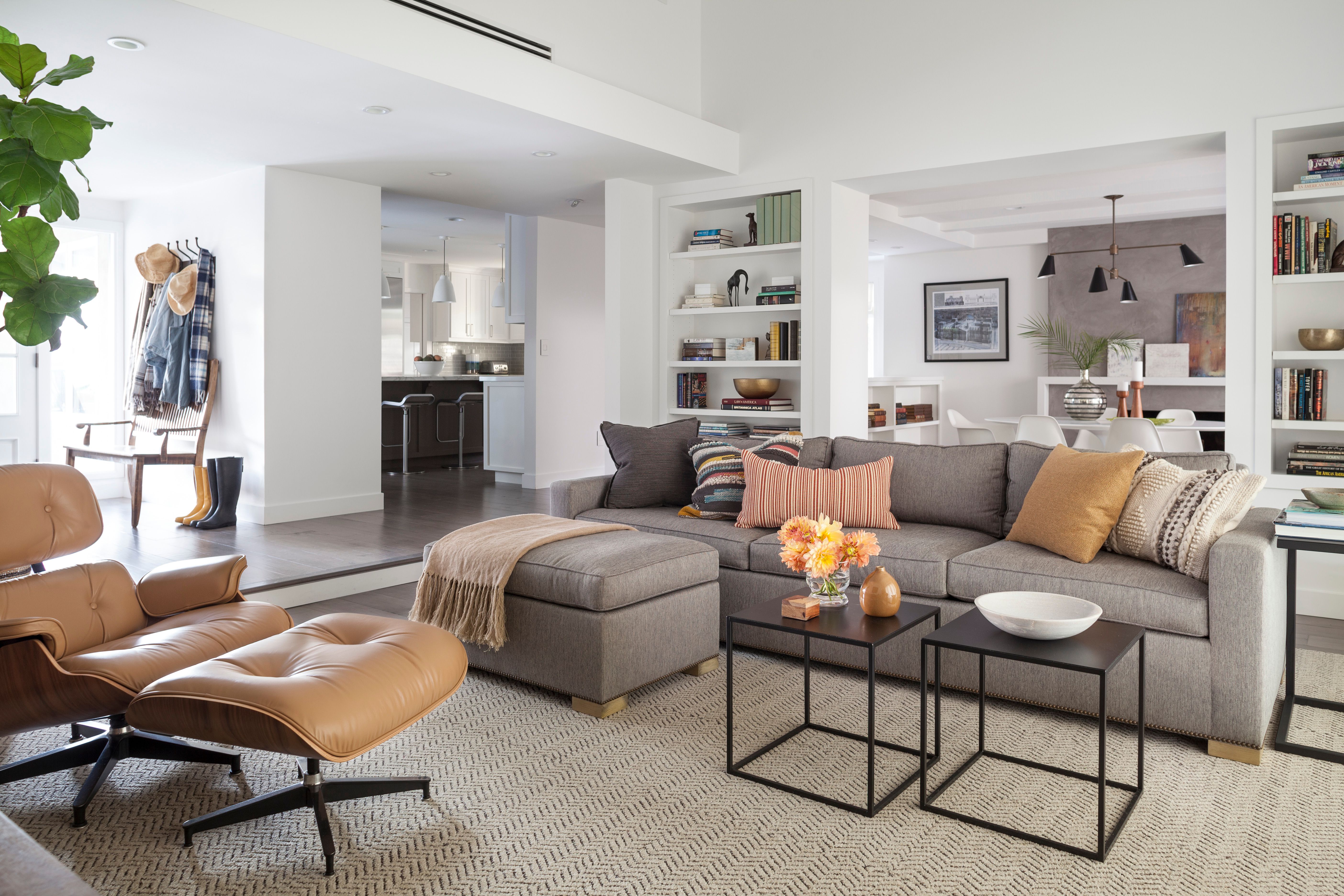 Gray sofa living room at night lit by a table lamp with a warm linen shade