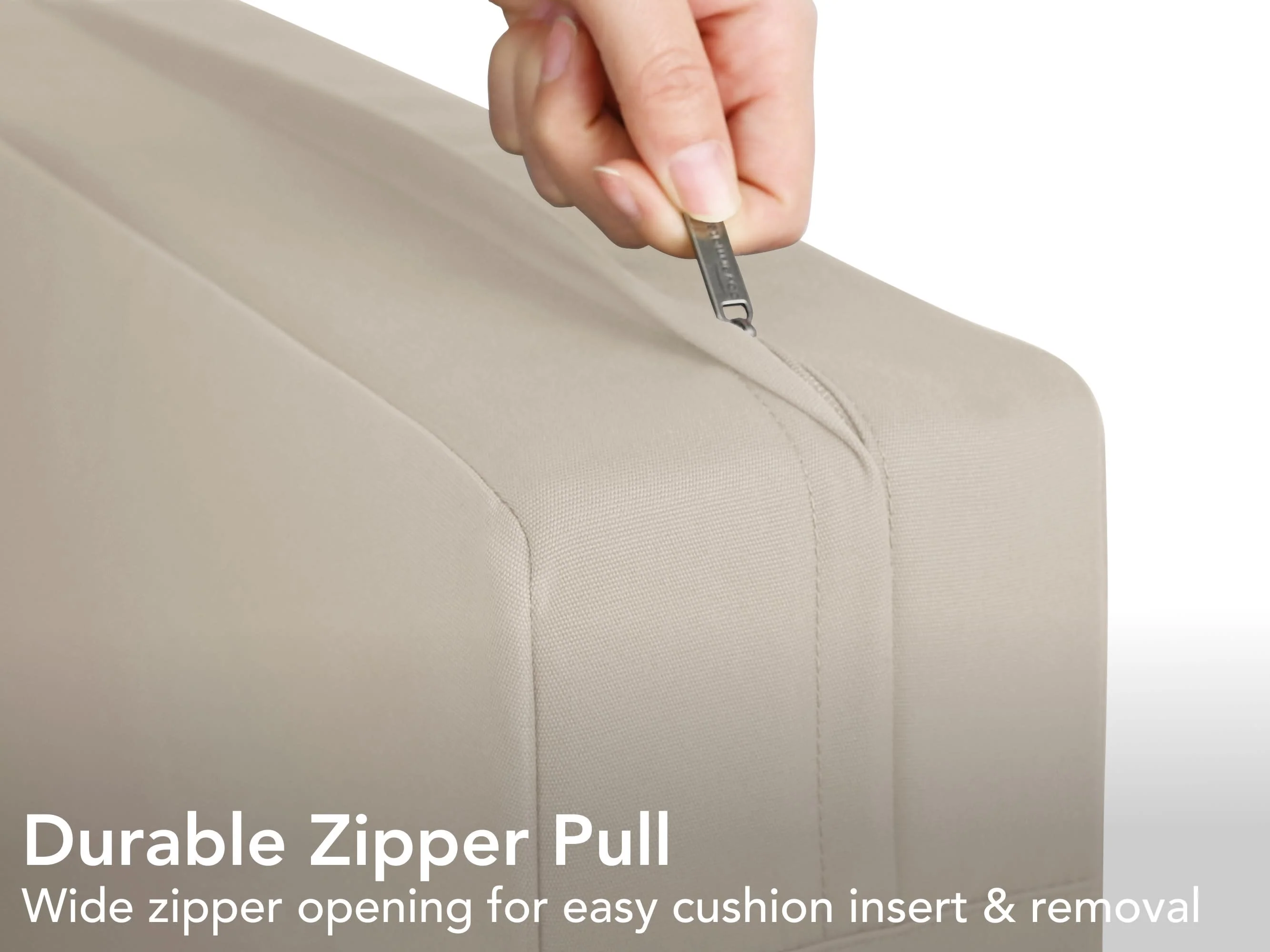 Hands pulling a foam cushion insert out of a zippered upholstery cover on a clean floor with towels laid out for drying