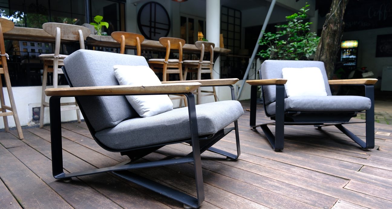Sofa cushions arranged standing upright with a small gap between each cushion for airflow, set on a clean rug with sunlight in the room
