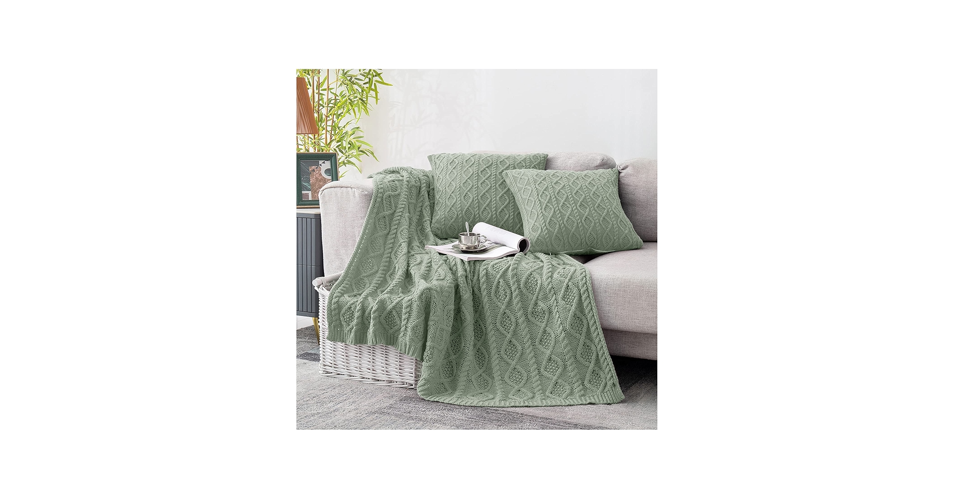 Sofa styled with two patterned pillows and a solid throw blanket to keep the look balanced