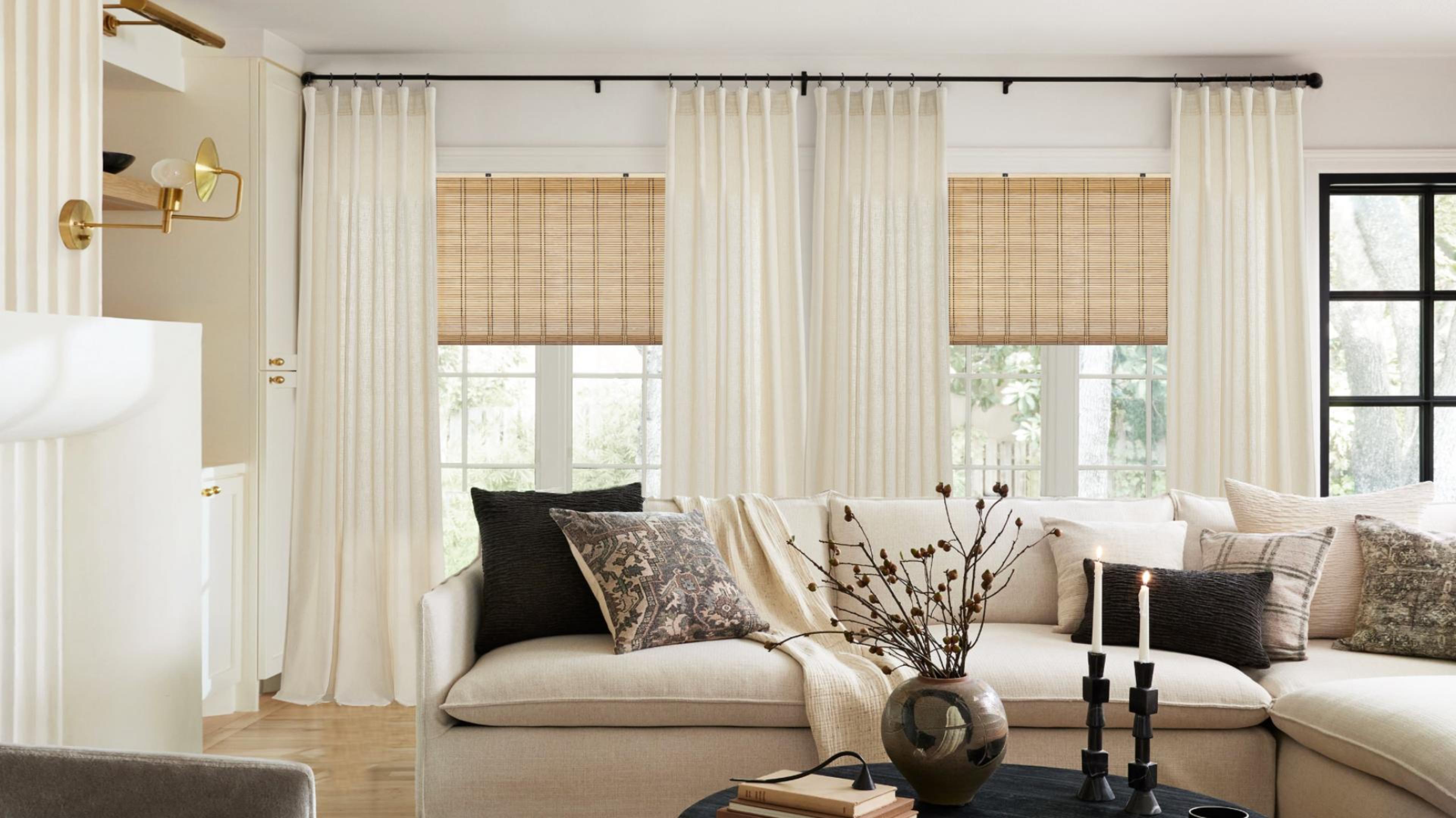 Warm ivory linen-look curtains filtering daylight in a neutral living room